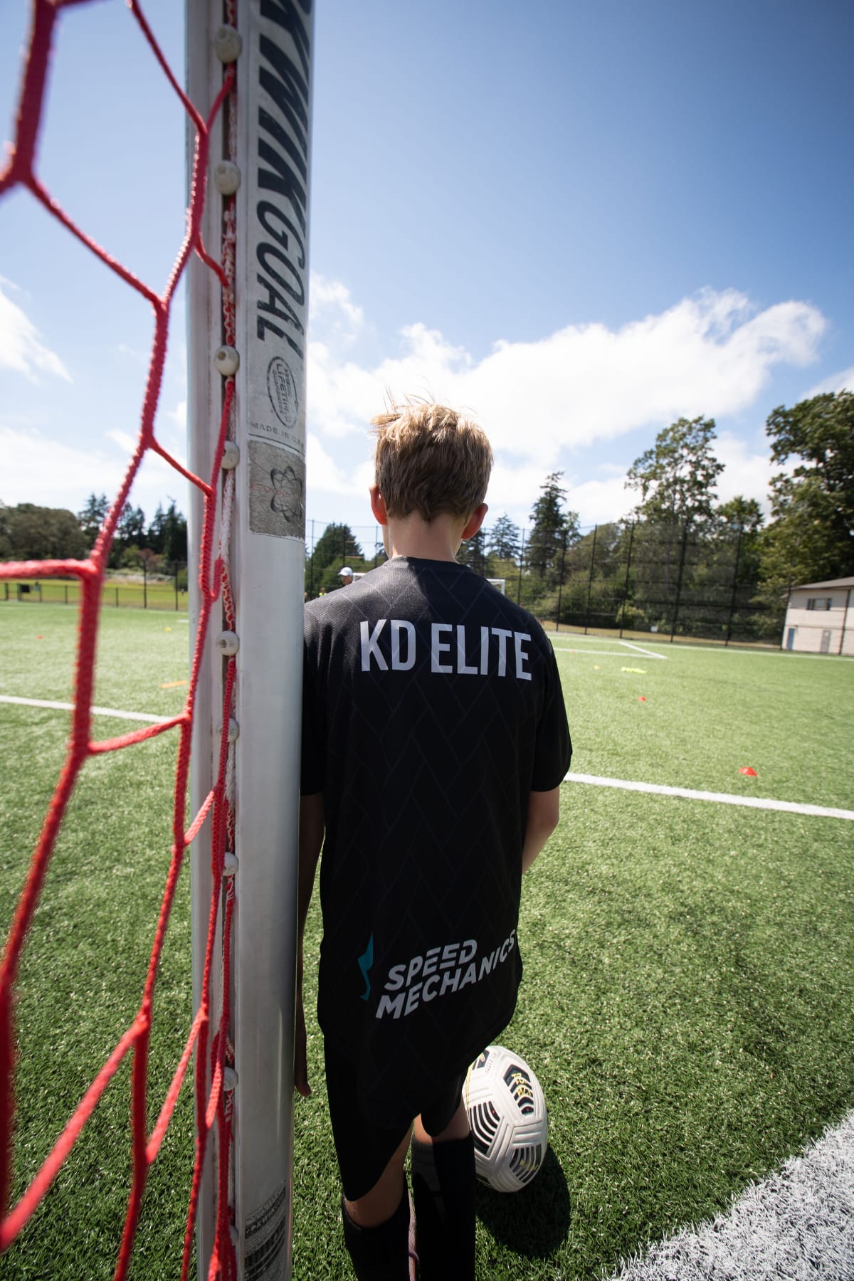 KD Elite player standing beside the goalpost with a ball at their feet